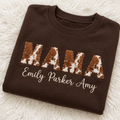 Folded brown MAMA sweatshirt with names